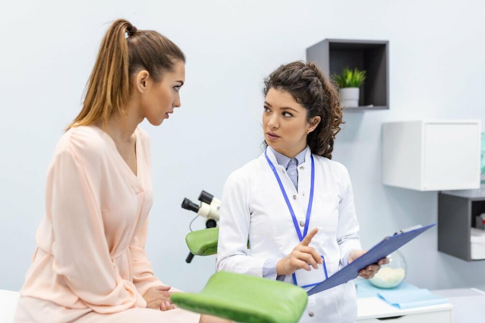 gynecologist is examined by patient who is sitting gynecological chair examination by gynecologist female health concept