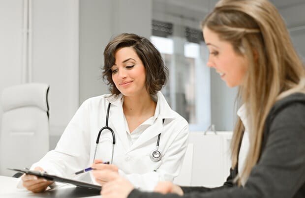 female doctor talking with female
