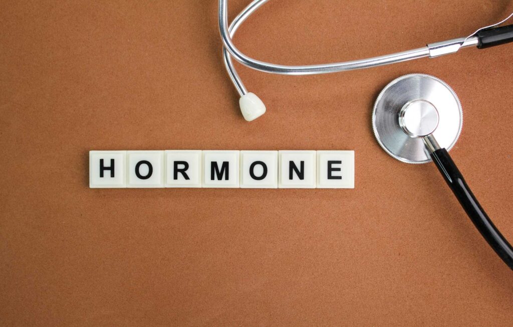 stethoscope and alphabet letters with the word hormone