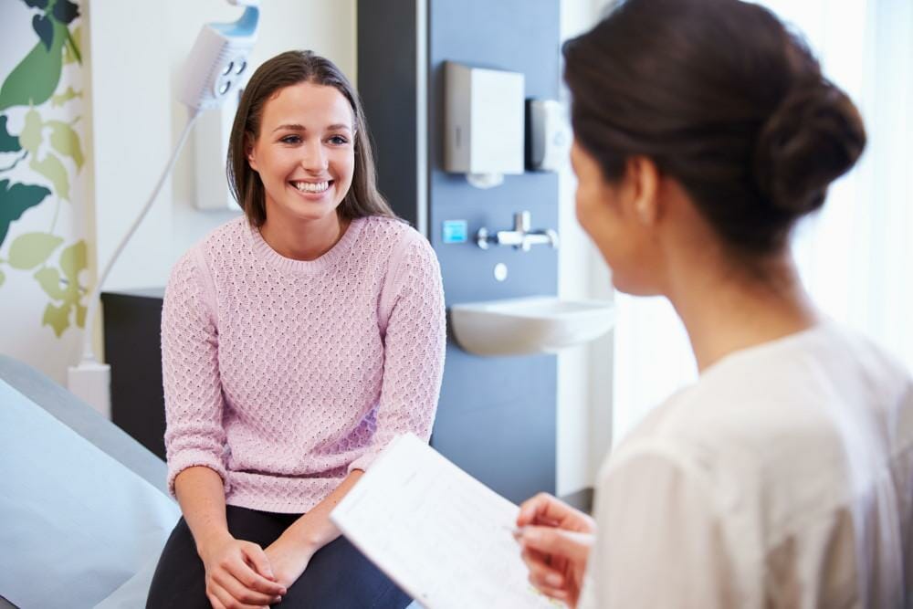 female doctor talking to female patient