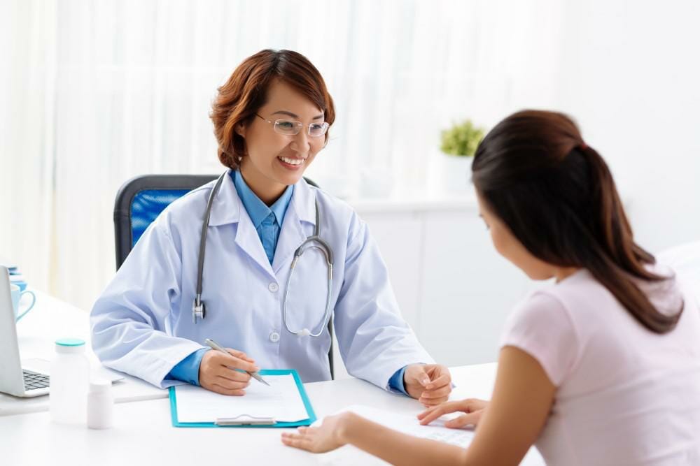 female doctor talking to female patient