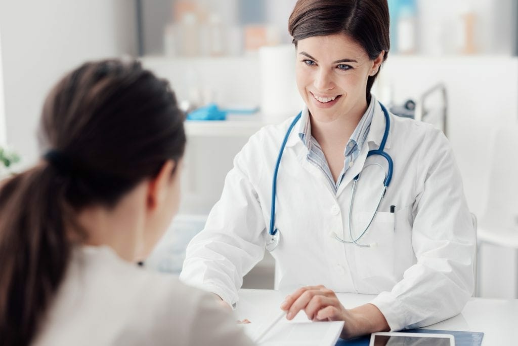 female doctor talking with female patient