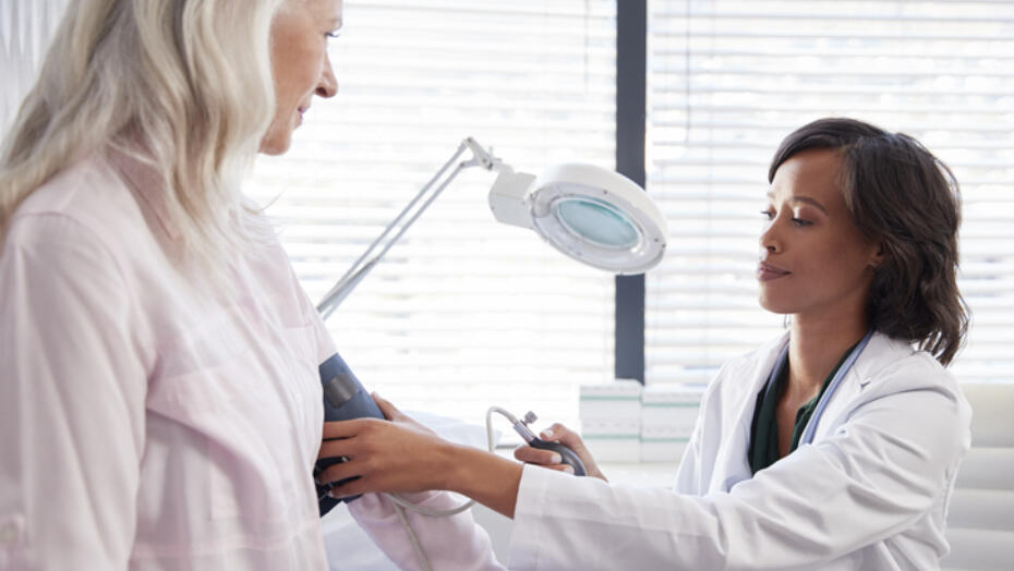 older woman getting her blood pressure checked by her doctor