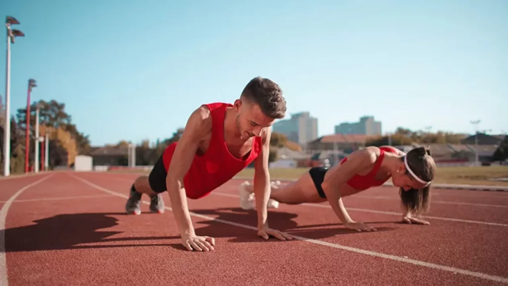 man and woman doing push ups