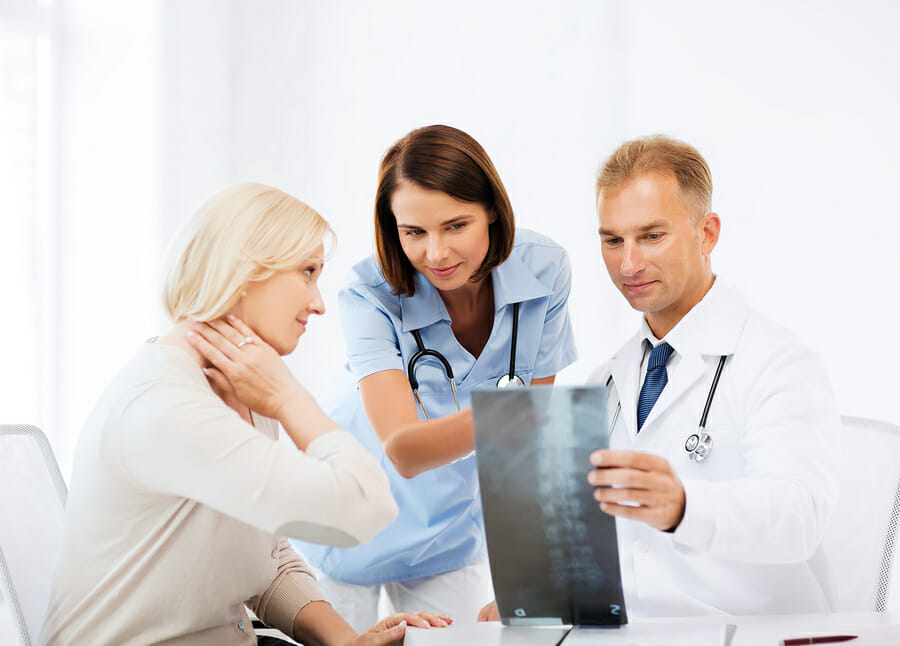 male and female doctor talking with female patient