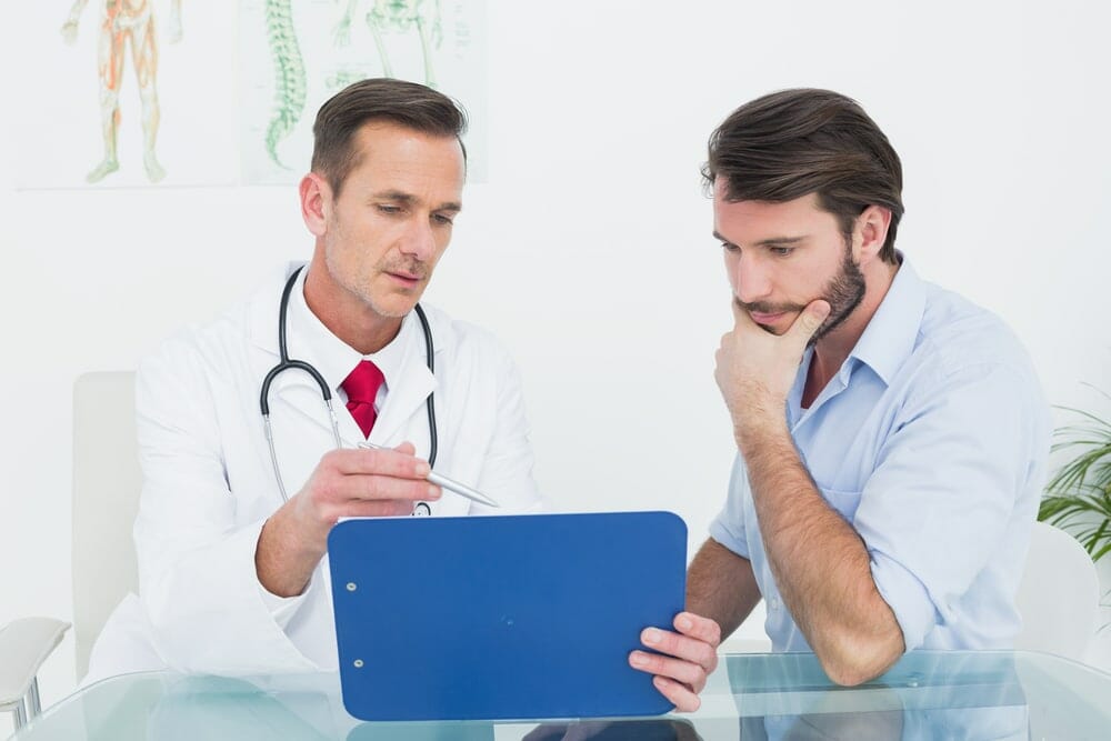 male doctor talking to male patient