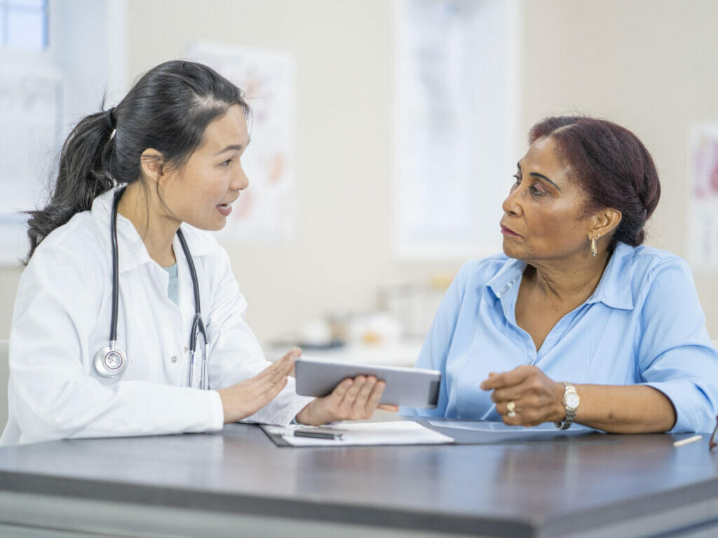 female doctor talking with female patient