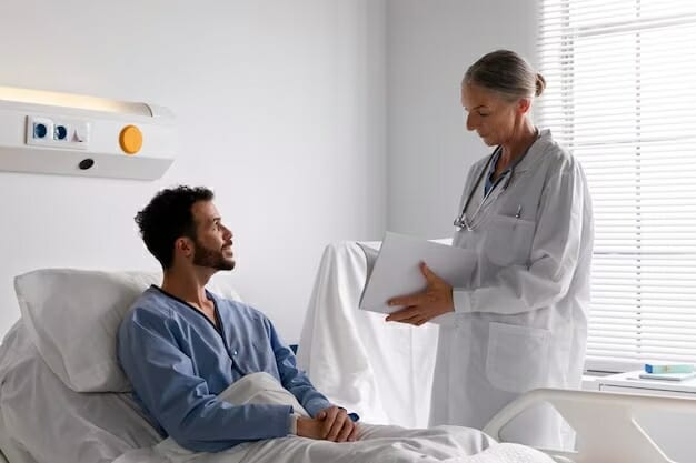 male patient in hospital bed talking to nurse