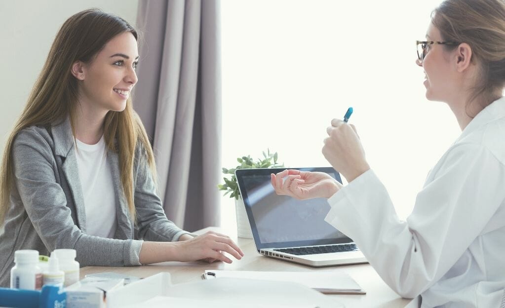 female doctor talking to female patient