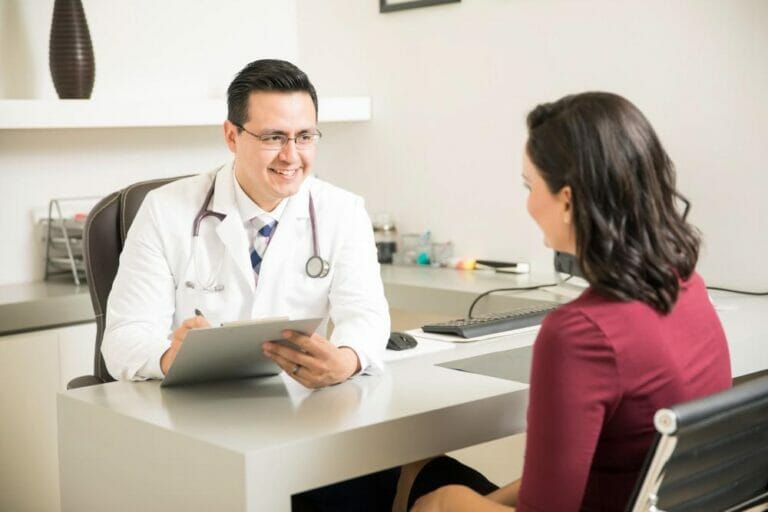 male doctor talking with female patient