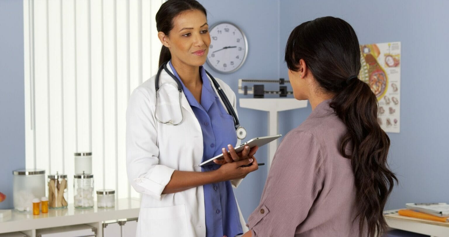 female doctor talking with female patient