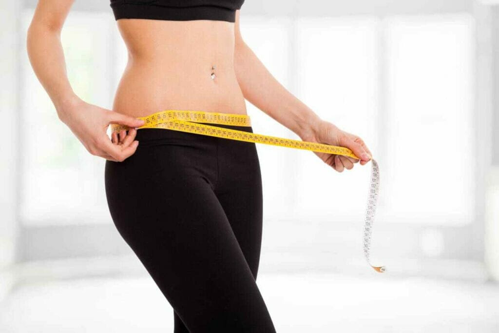 woman measuring her waist