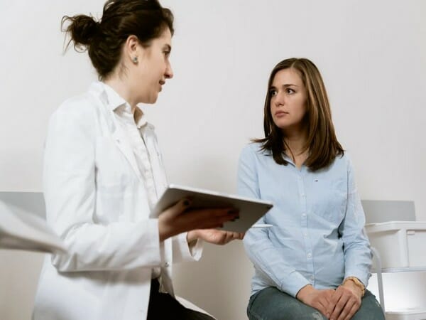 female doctor talking with female patient