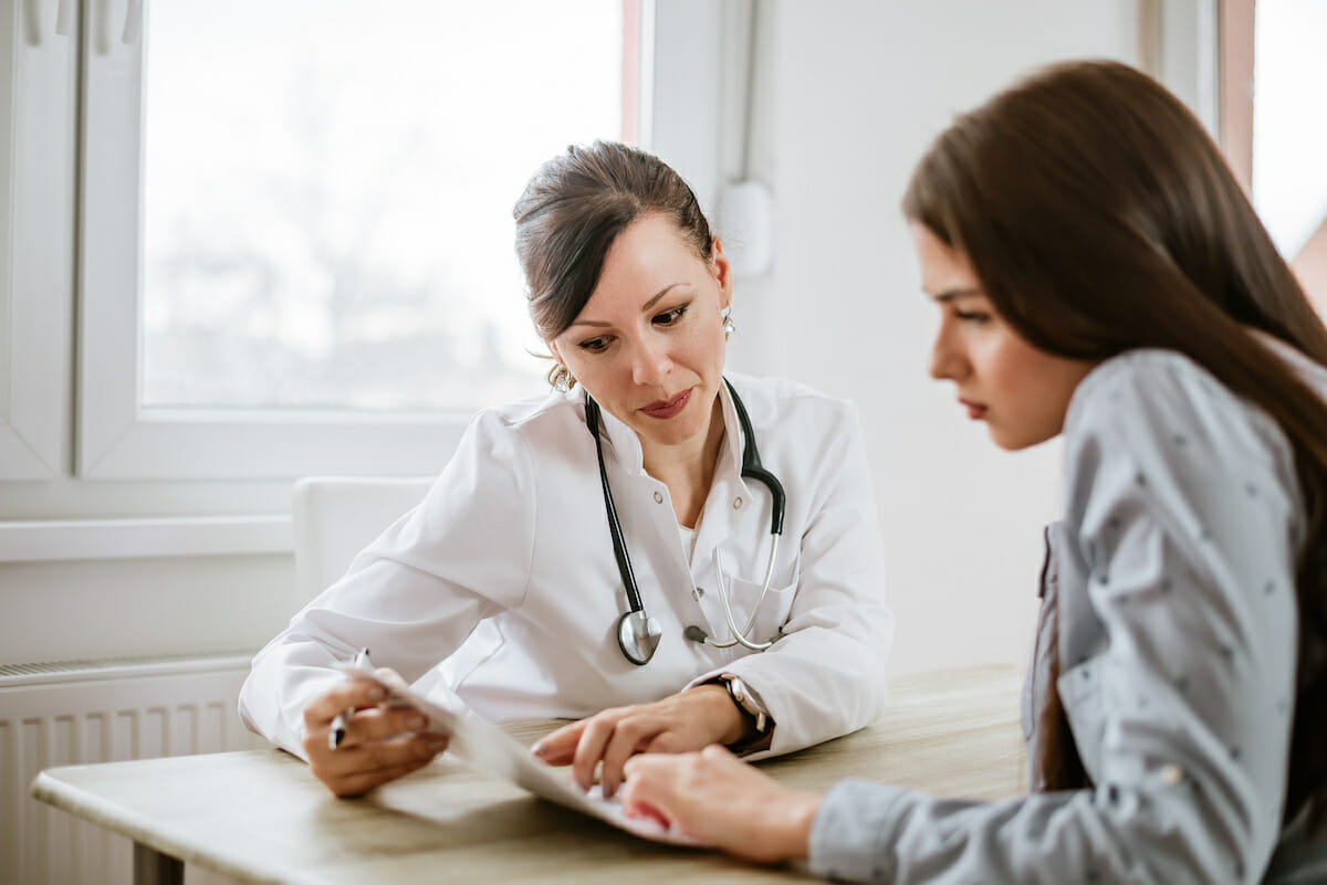 female doctor talking with female patient