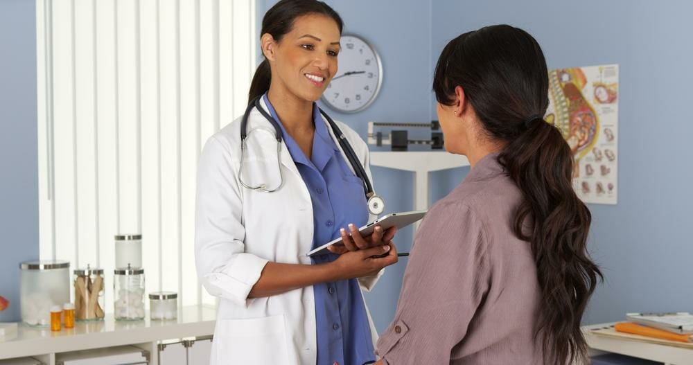 female doctor talking with female patient