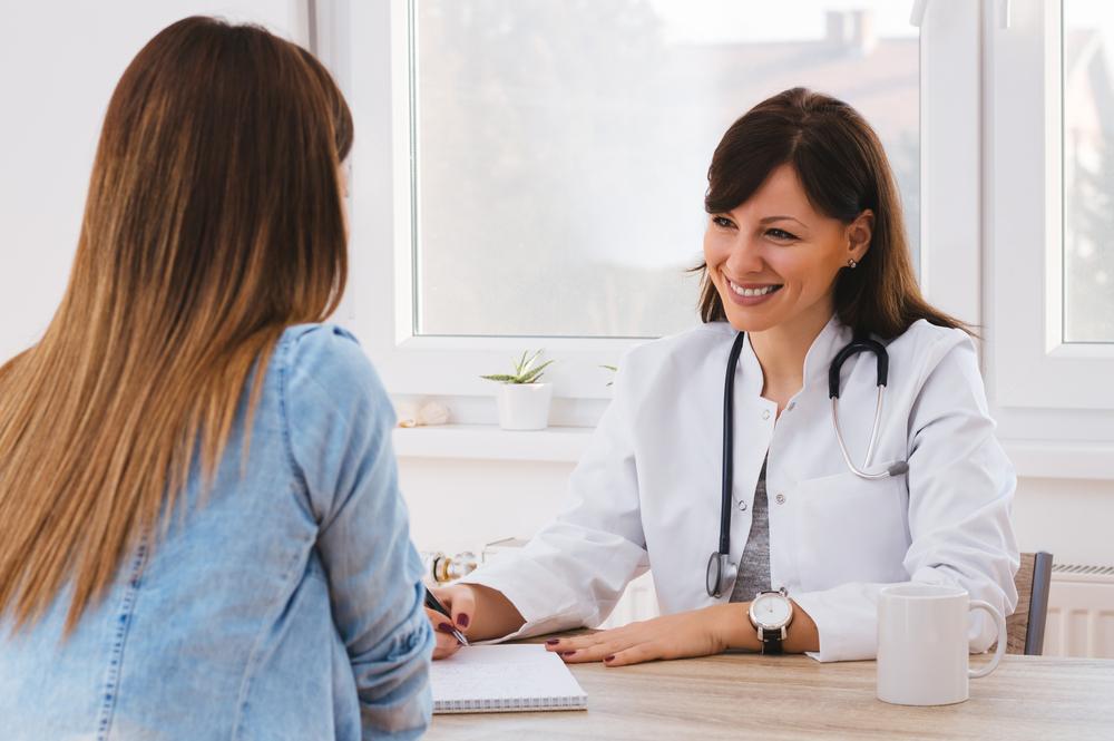 female doctor talking with female patient