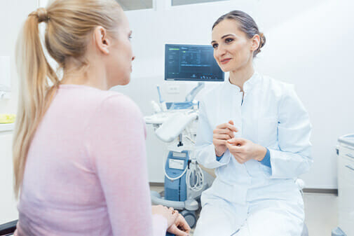 female doctor talking with female patient