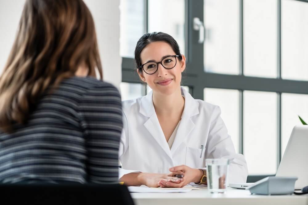 female doctor talking with female patient