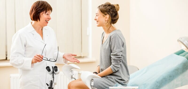 female doctor talking with female patient