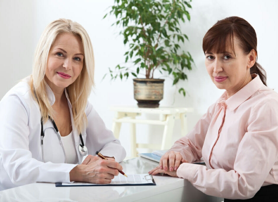 female doctor talking with female patient