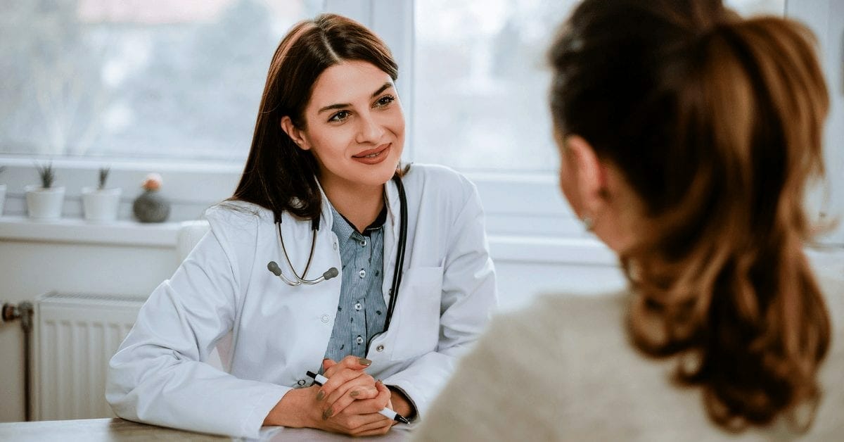 female doctor talking with female patient