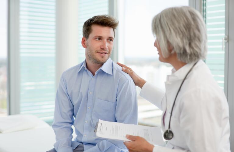 female doctor talking with male patient