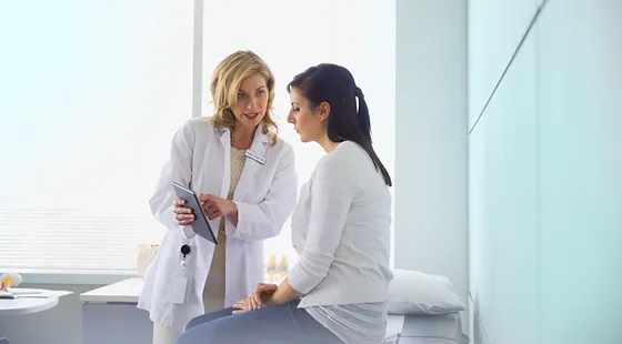 female doctor talking with female patient