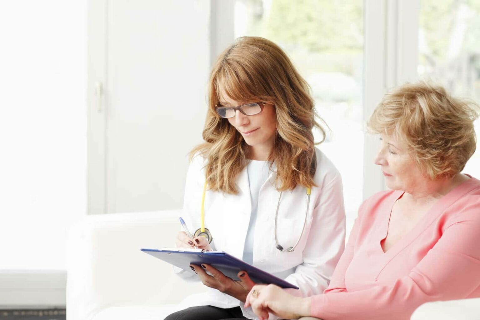 female doctor talking with female patient