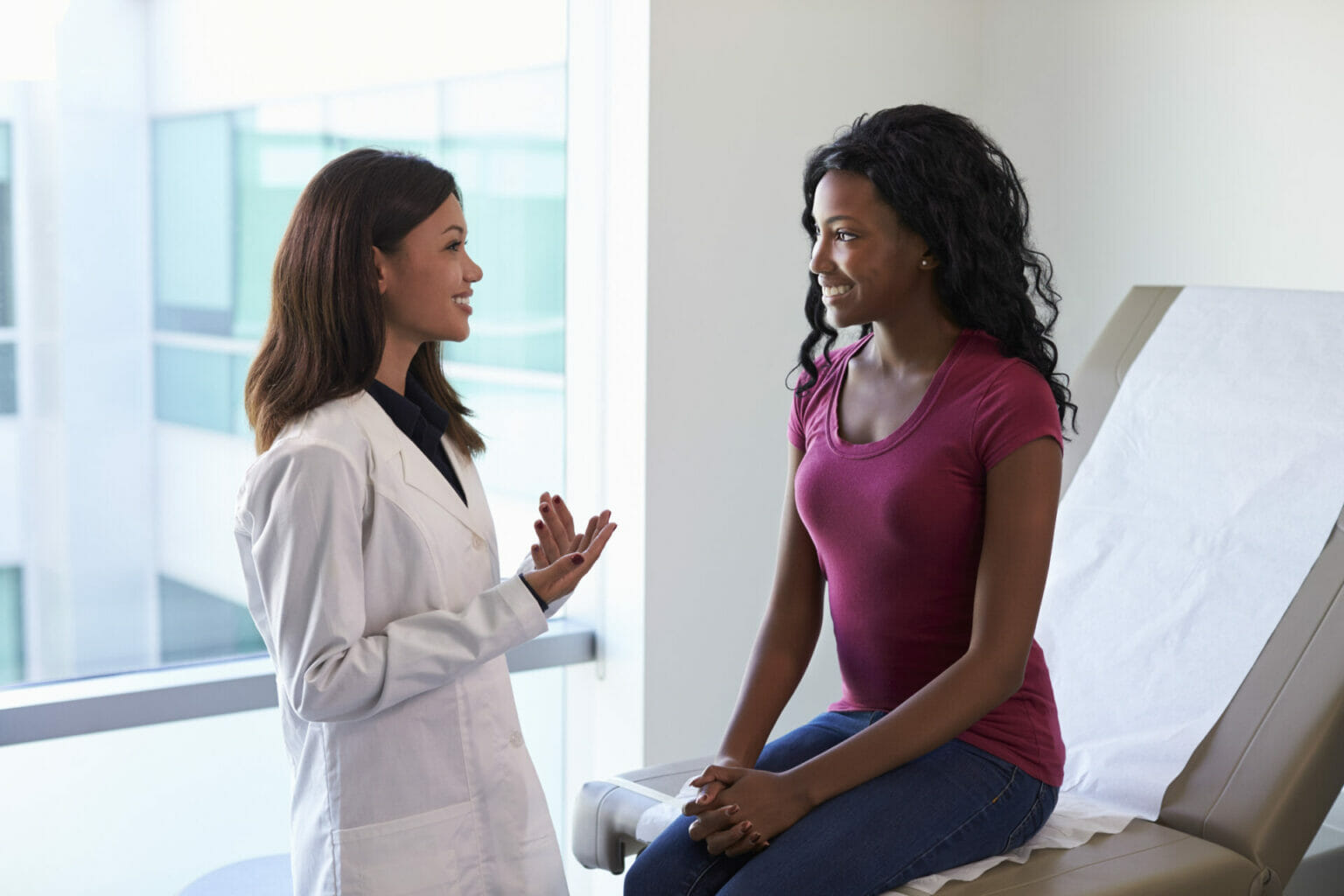 female doctor talking with female patient