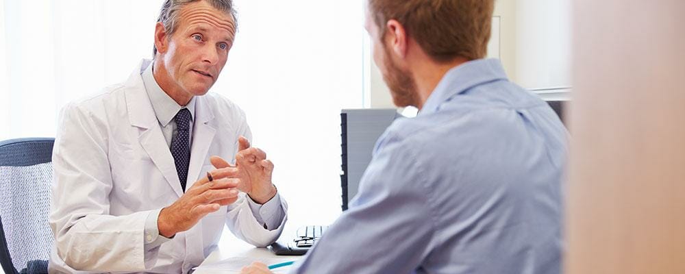 male doctor talking with male patient