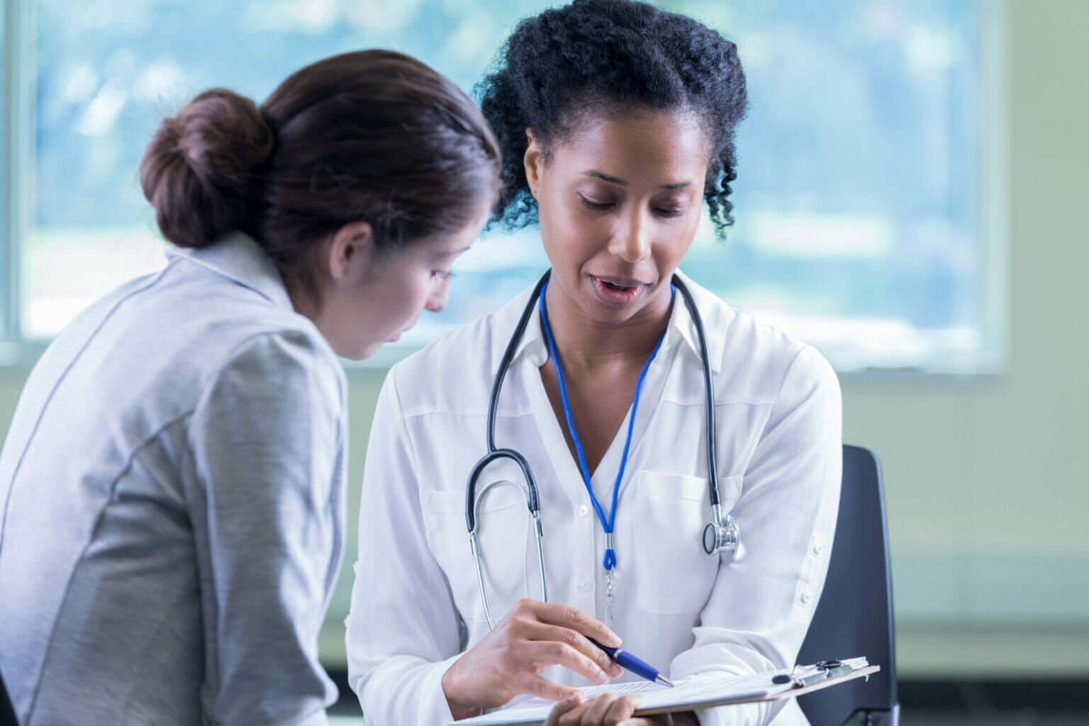 female doctor talking with female patient