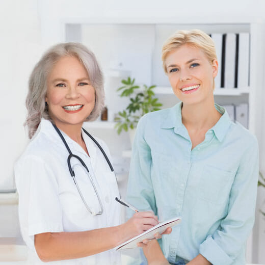 female doctor talking with female patient