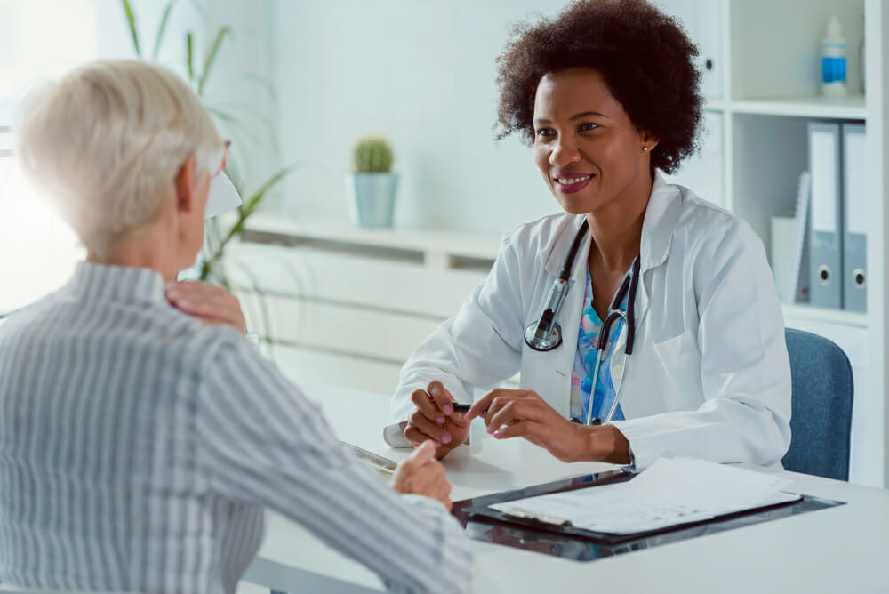 female doctor talking with female patient