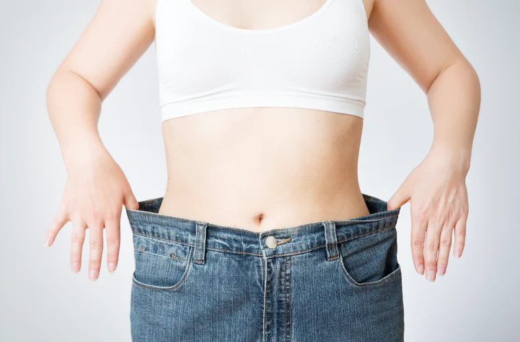 woman measuring her waist